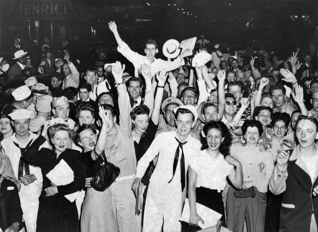 People celebrate news of the end of World War II at Randolph and Dearborn streets in Chicago on Aug. 14, 1945. (Joe Mastruzzo/Chicago Herald-American)