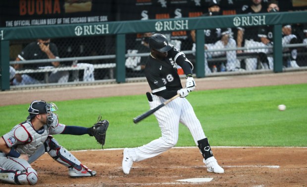 White Sox center fielder Luis Robert Jr. swings for a...