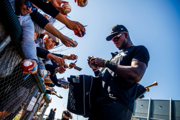 White Sox prospect Luis Robert signs autographs for fans during...