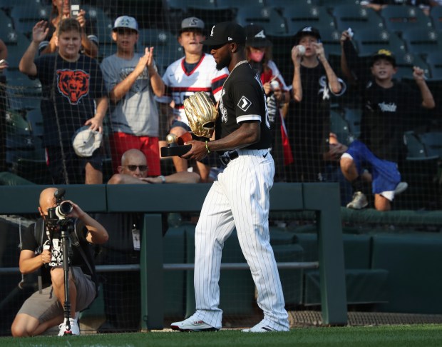 White Sox outfielder Luis Robert Jr. carries his 2020 Gold...