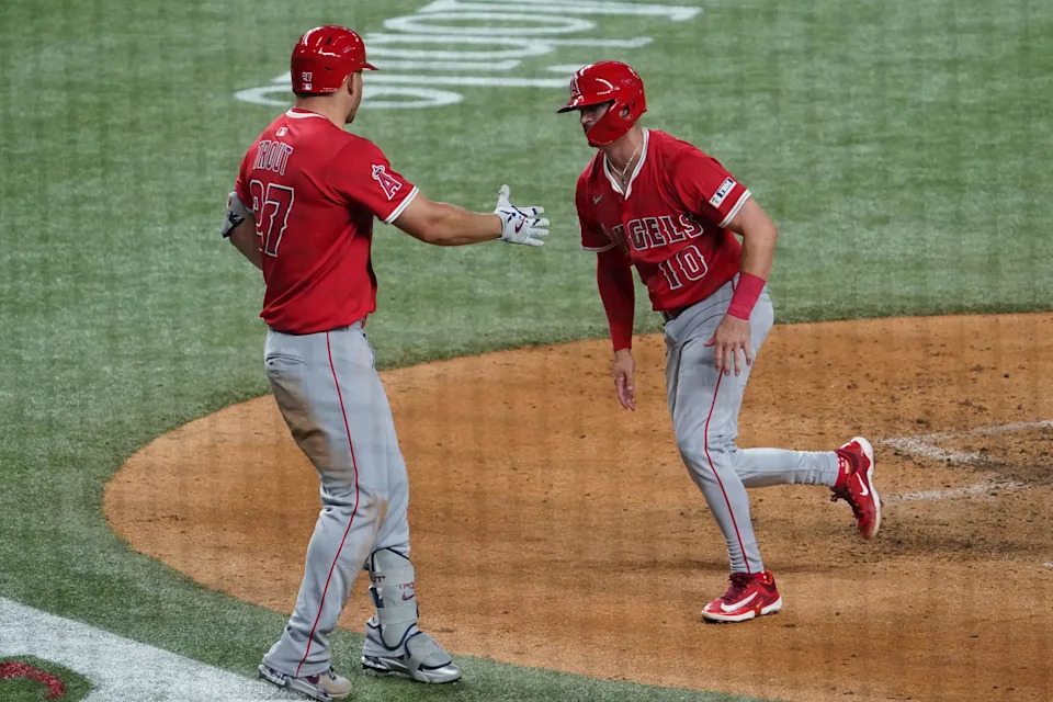 Apr 16, 2025; Arlington, Texas, USA; Los Angeles Angels shortstop Kevin Newman (10) is greeted by center fielder Mike Trout (27) after scoring during the sixth inning against the Texas Rangers at Globe Life Field. Mandatory Credit: Raymond Carlin III-Imagn Images