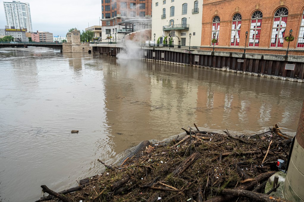 Debris piles up on a bridge piling on the Milwaukee River after heavy rain in the area on August 10, 2025 in Milwaukee, Wisconsin. 