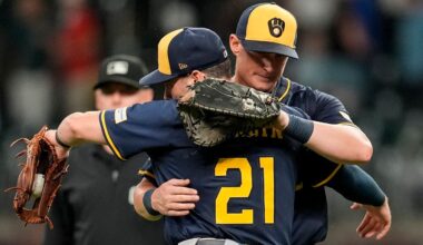 Milwaukee Brewers' Caleb Durbin (21) embraces Andrew Vaughn (28) after a baseball game against the Atlanta Braves, Tuesday, Aug. 5, 2025, in Atlanta.