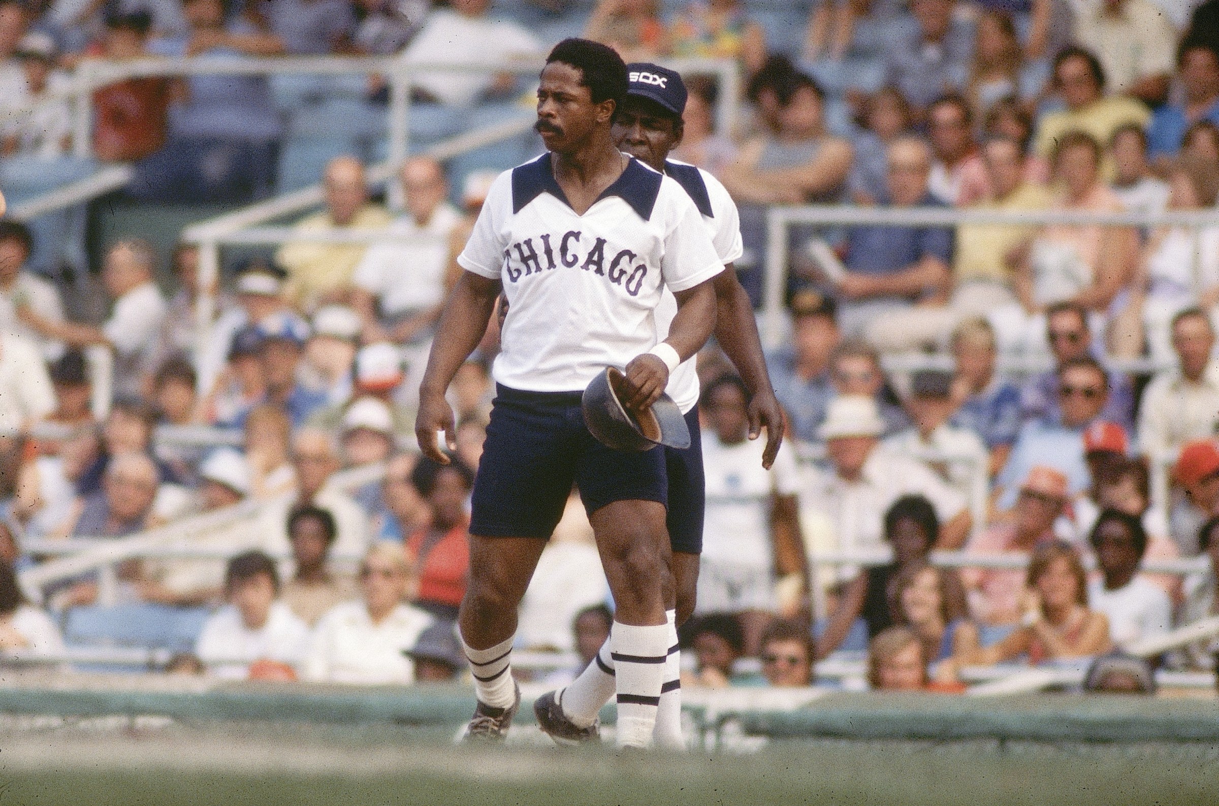 Ralph Garr (48) held at 1st base with teammate Minnie Monoso (9) as coach during game vs Baltimore Orioles, Sox wearing shorts with uniform, Chicago, IL 8/20/1976 (Photo by Manny Millan/Sports Illustrated via Getty Images) (SetNumber: X20742 TK3)