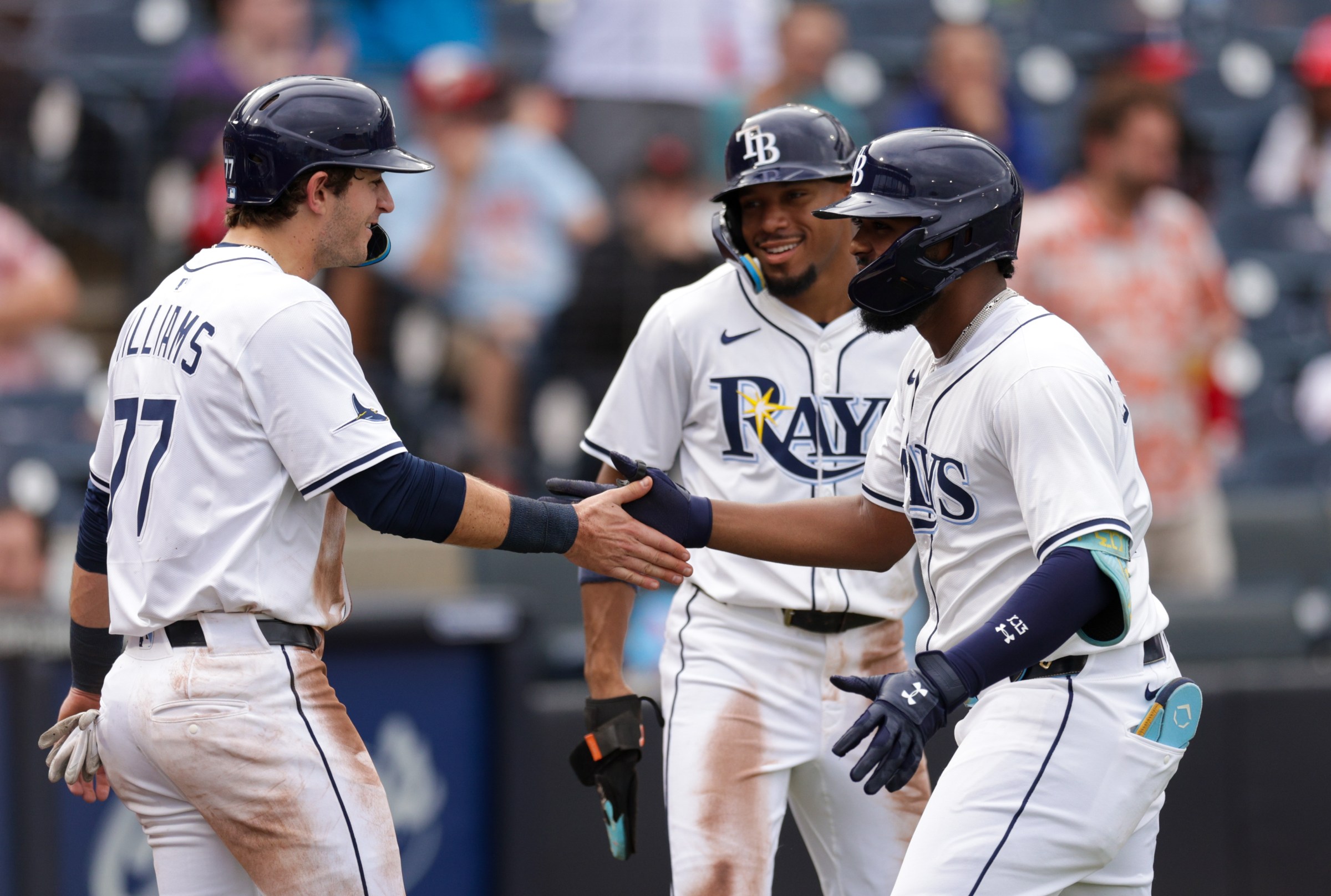 Aug 24, 2025; Tampa, Florida, USA; Tampa Bay Rays third baseman Junior Caminero (13) celebrates with shortstop Carson Williams (77) after hitting a grand slam against the St. Louis Cardinals in the fifth inning at George M. Steinbrenner Field. Mandatory Credit: Nathan Ray Seebeck-Imagn Images