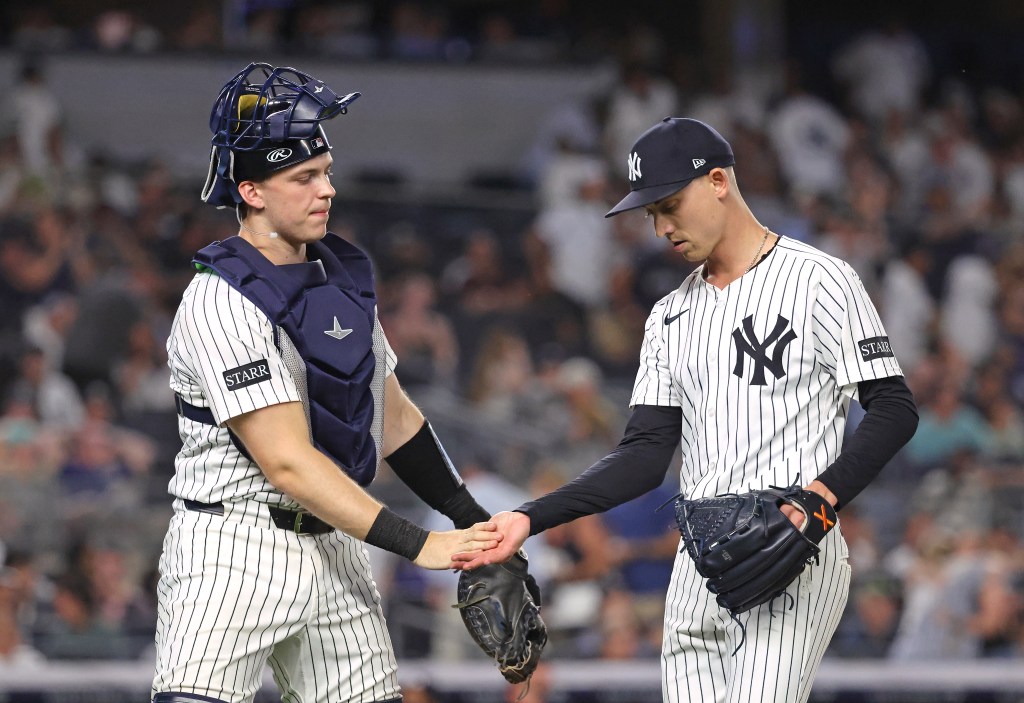 New York Yankees catcher and pitcher shaking hands.