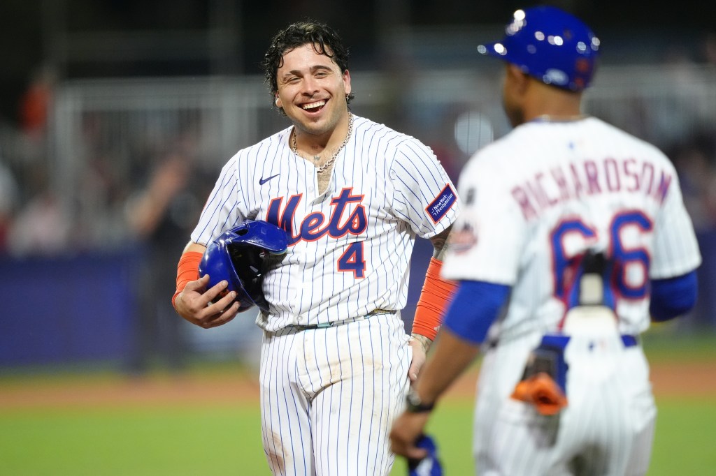 Francisco Alvarez #4 of the New York Mets smiles after hitting a single.