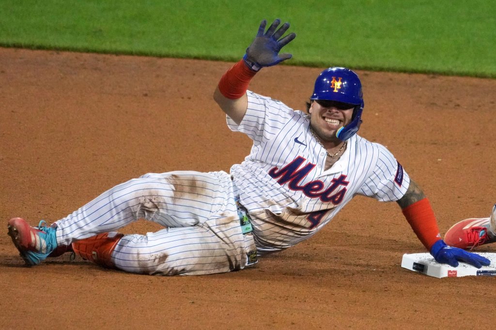 New York Mets player Francisco Alvarez sliding into second base.