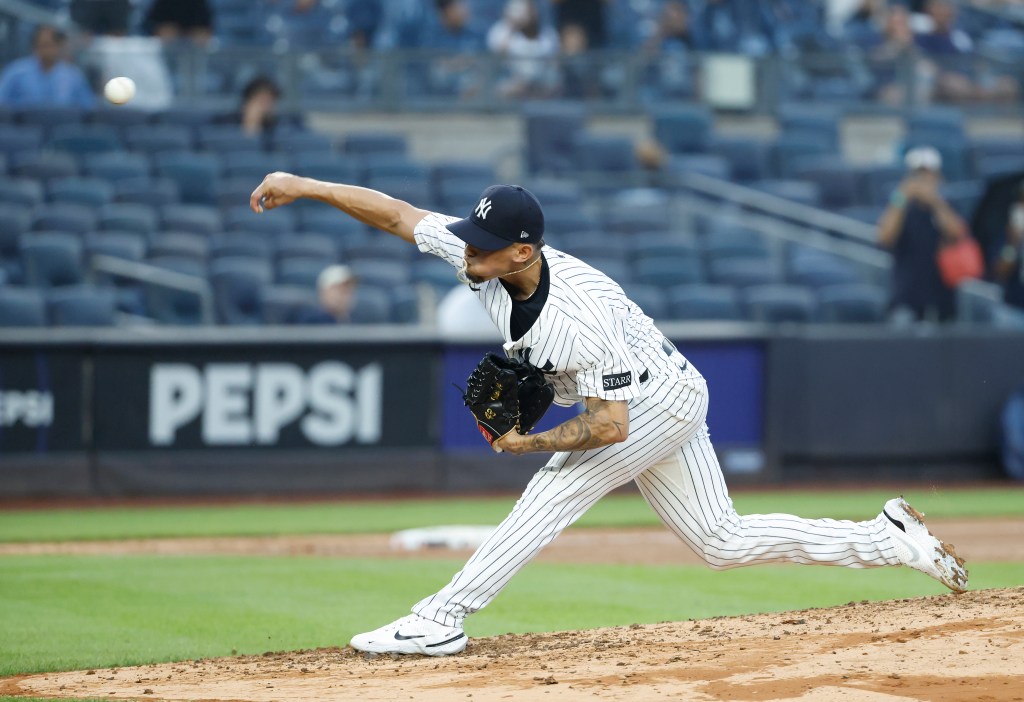 New York Yankees pitcher throwing a baseball.