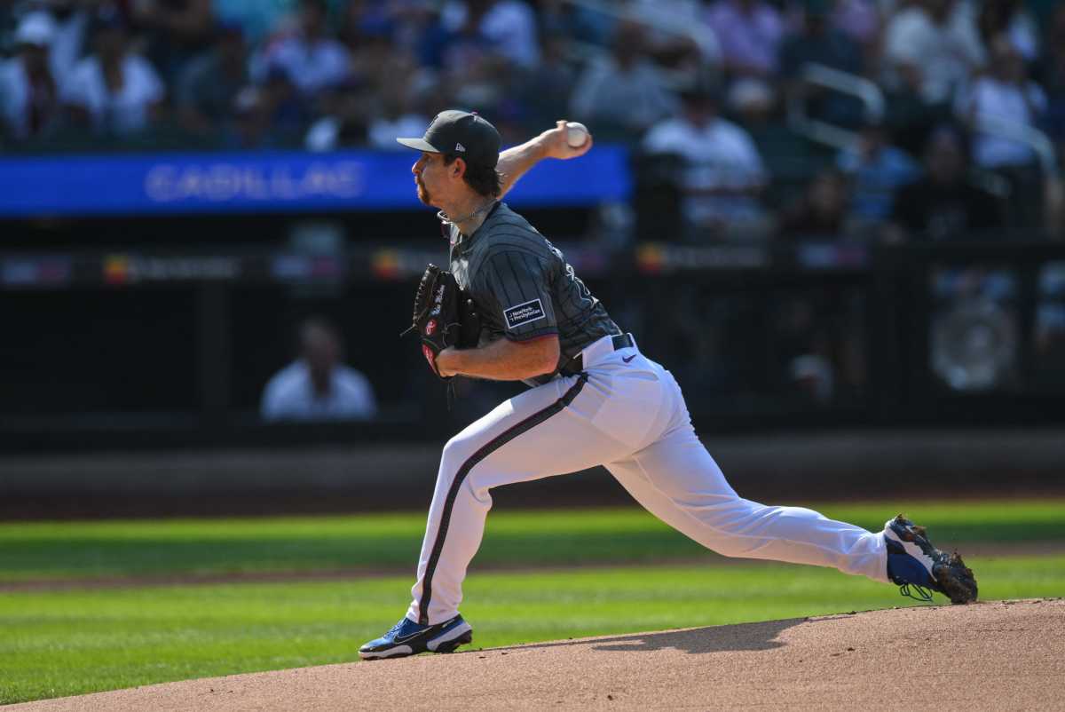 Mets pitcher in gray uniform throws pitch offf mound
