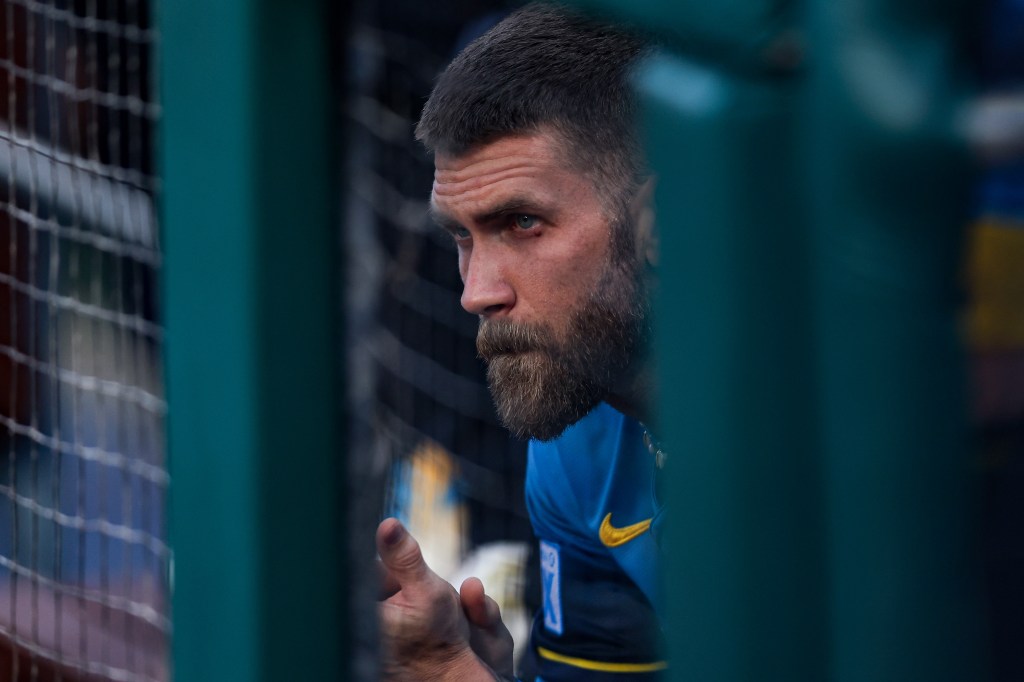 Bryce Harper, Philadelphia Phillies player, viewed from behind a fence.