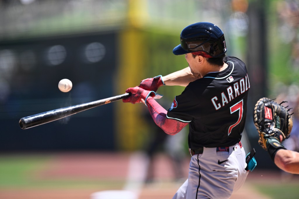 Baseball player swinging bat.