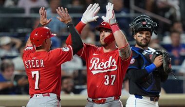 New York Mets catcher Luis Torrens watches as Cincinnati Reds' Tyler Stephenson (37) celebrates with Spencer Steer (7) after they score on two-run home run by Stephenson during the sixth inning of a baseball game Friday, July 18, 2025, in New York.