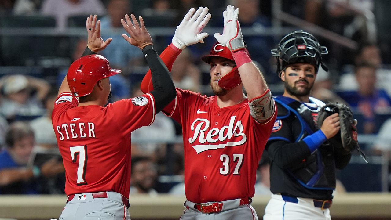 New York Mets catcher Luis Torrens watches as Cincinnati Reds' Tyler Stephenson (37) celebrates with Spencer Steer (7) after they score on two-run home run by Stephenson during the sixth inning of a baseball game Friday, July 18, 2025, in New York.