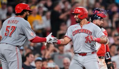 Cincinnati Reds' Christian Encarnacion-Strand, right, is congratulated by Rece Hinds (57) after his grand slam drive against the Boston Red Sox during the seventh inning of a baseball game at Fenway Park, Wednesday, July 2, 2025, in Boston. (AP Photo/Charles Krupa)
