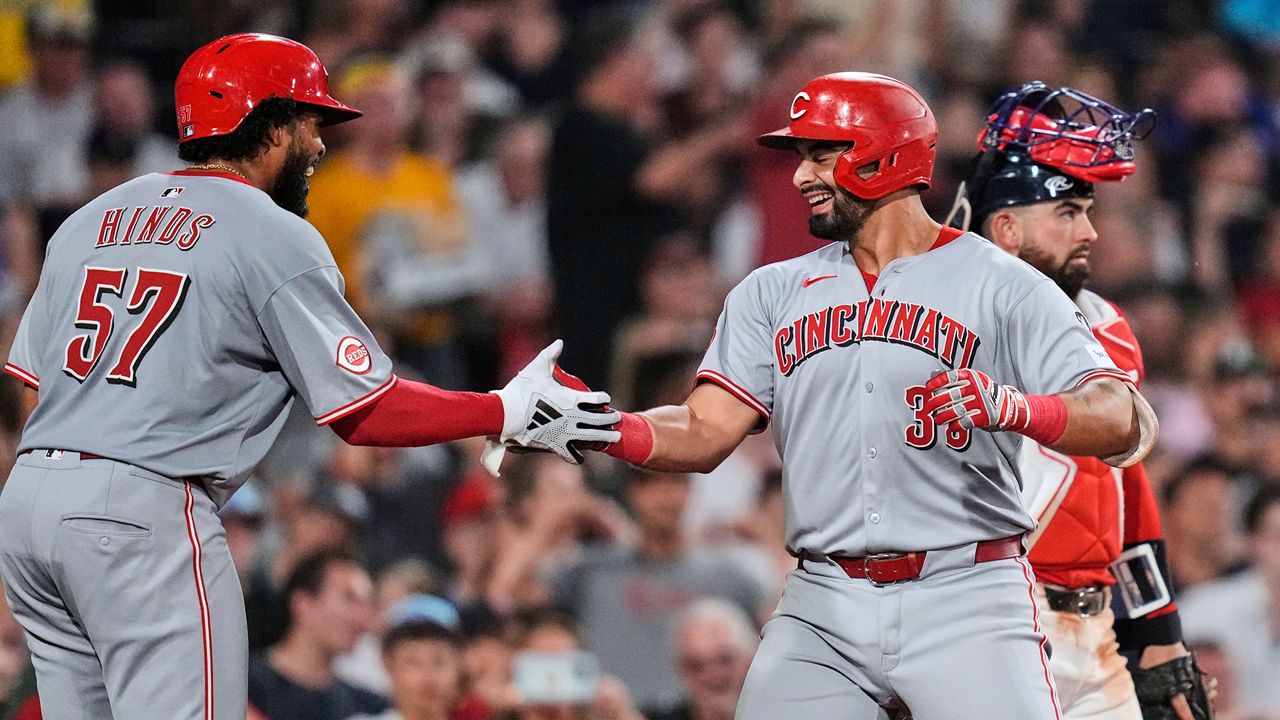 Cincinnati Reds' Christian Encarnacion-Strand, right, is congratulated by Rece Hinds (57) after his grand slam drive against the Boston Red Sox during the seventh inning of a baseball game at Fenway Park, Wednesday, July 2, 2025, in Boston. (AP Photo/Charles Krupa)