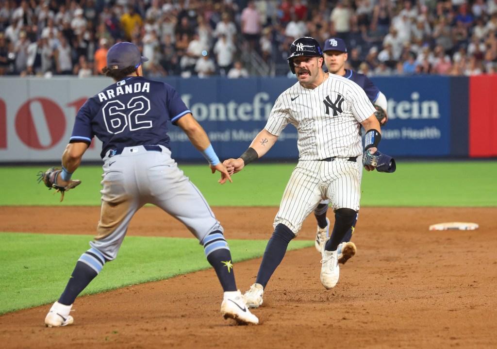 New York Yankees catcher Austin Wells in a rundown during a game against the Tampa Bay Rays.
