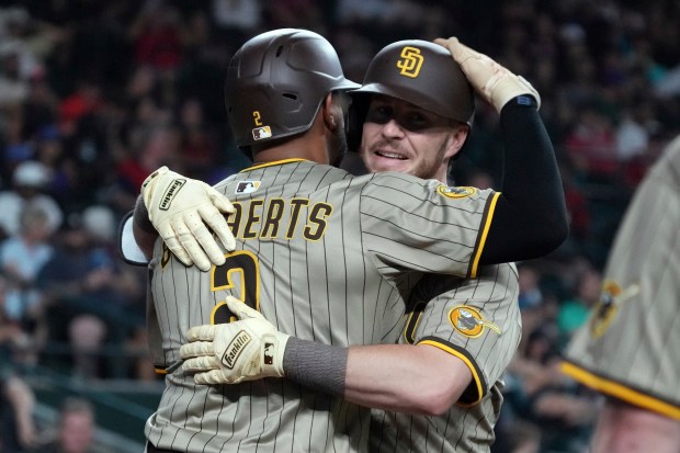 The Padres' Ryan O'Hearn, right, celebrates with Xander Bogaerts after hitting a game-tying home run in the ninth inning of Wednesday's victory over the Diamondbacks. (AP Photo/Rick Scuteri)