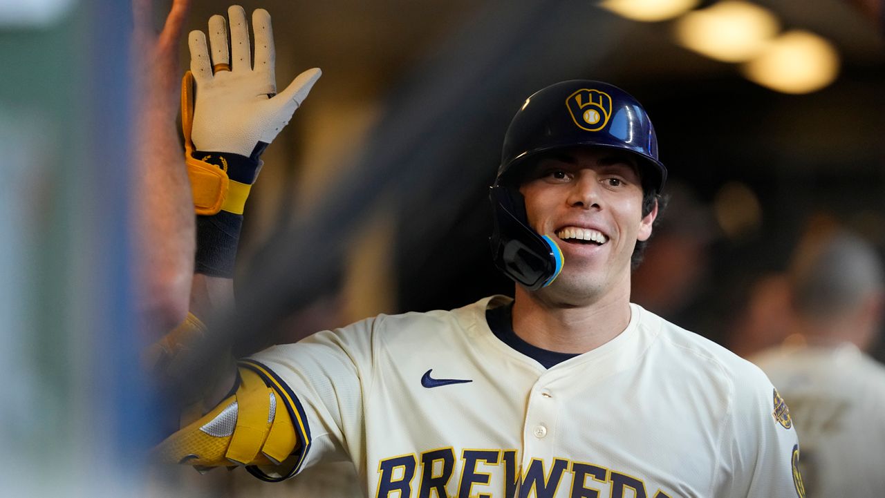Milwaukee Brewers' Christian Yelich smiles in the dugout after hitting a solo home run during the third inning of a baseball game against the Pittsburgh Pirates, Monday, Aug. 11, 2025, in Milwaukee.