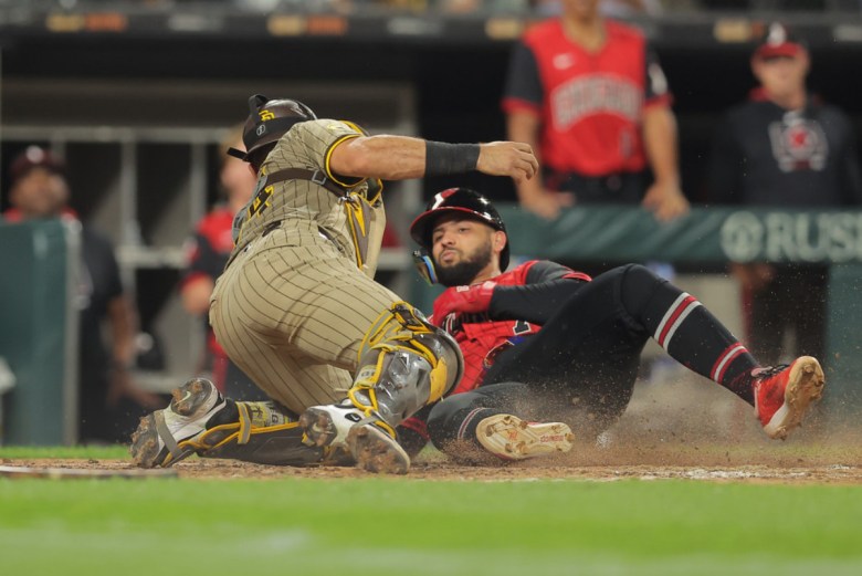 Two men at home plate on a baseball diamond. Edgar Quero #7 of the White Sox beats the tag home by Freddy Fermin #54 of the Padres during a game on Sept. 19.