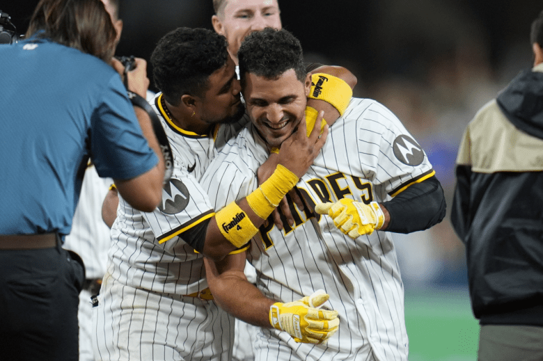 Padres teammates hug after a win.