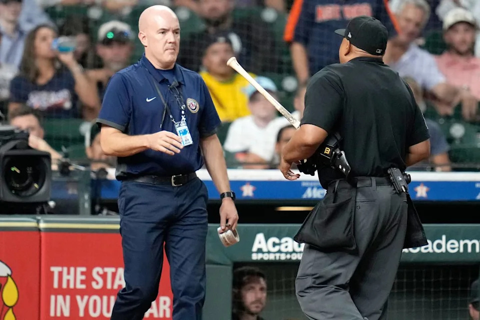 Home plate umpire Adrian Johnson carries Houston Astros’ Taylor Trammell’s bat over to an authenticator after the the New York Yankees asked to challenge a scuff on the bat during the ninth inning of a baseball game Thursday, Sept. 4, 2025, in Houston. AP