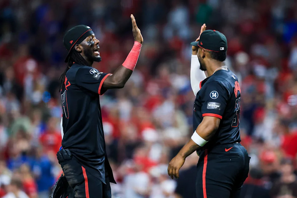 Elly De La Cruz and designated hitter Miguel Andujar celebrate after the Reds' third straight victory, 7-4 over the Chicago Cubs at Great American Ball Park on Sept. 19.
