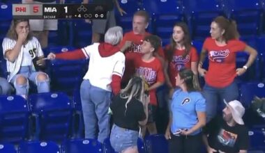 A woman Phillies fan (white jersey) was seen berating a man for beating her to a foul ball