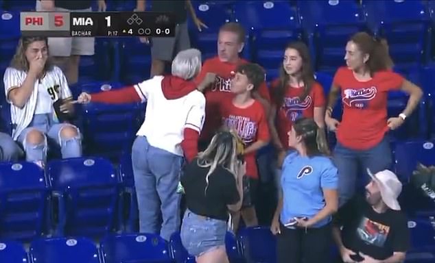 A woman Phillies fan (white jersey) was seen berating Drew Feltwell for beating her to a home run