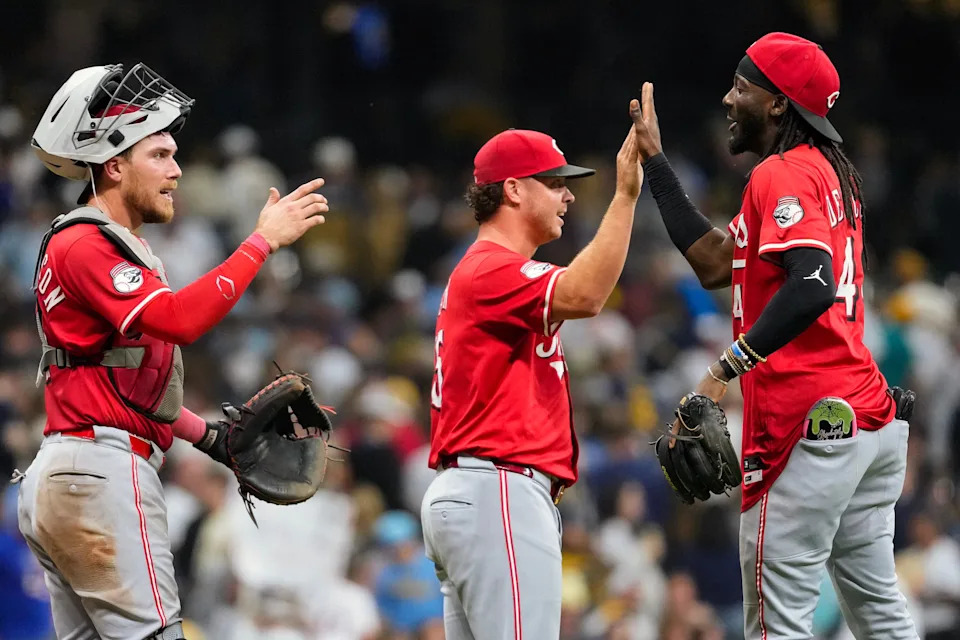 Reds shortstop Elly De La Cruz (at right) high fives teammates following a Sept. 26 win over the Brewers at American Family Field.