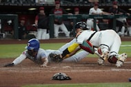 Texas Rangers' Ezequiel Duran, left, scores against Arizona Diamondbacks catcher Gabriel...