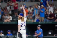 Texas Rangers pitcher Jon Gray (22) reacts after a leaping catch by outfielder Michael...