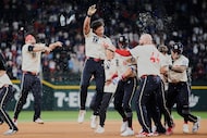 Texas Rangers' Dustin Harris (38) celebrates with the team after hitting a game-winning...