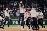 Texas Rangers' Dustin Harris (38) celebrates with the team after hitting a game-winning...