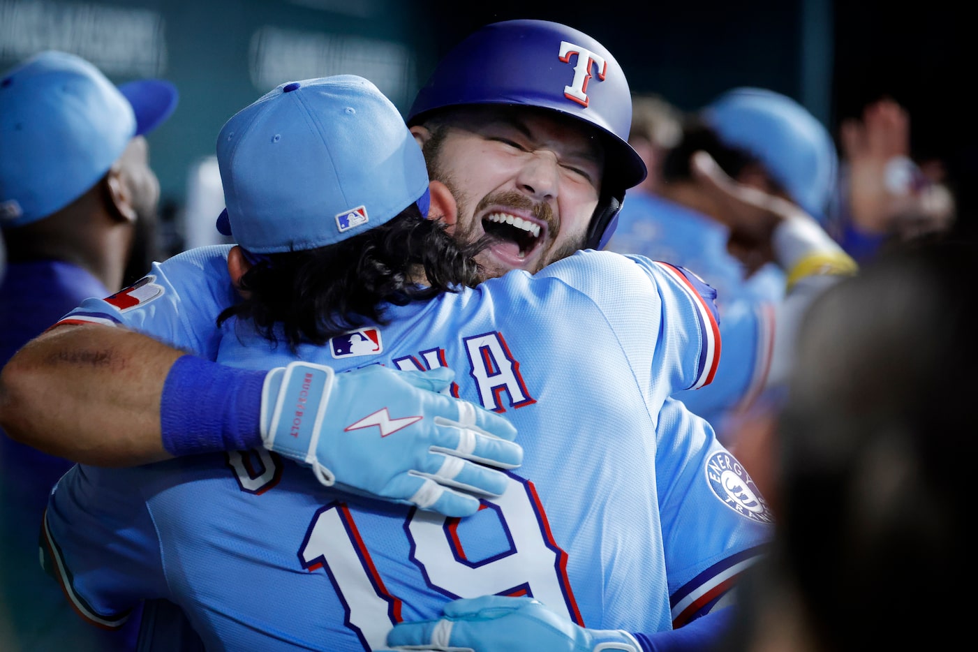 Texas Rangers first base Jake Burger (facing) is congratulated by teammate Alejandro Osuna...