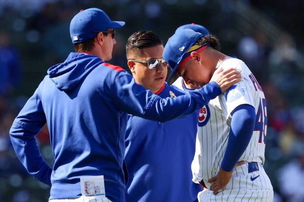 Chicago Cubs manager Craig Counsell puts his hand on the shoulder of closer Daniel Palencia (48) after he blows a save and appears injured in the top of the ninth inning at Wrigley Field on Sept. 7, 2025, in (Chicago. Stacey Wescott/Chicago Tribune)