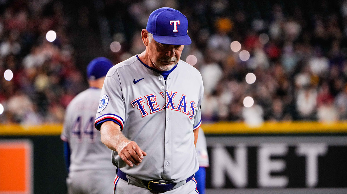 Texas Rangers manager Bruce Bochy (15) walks back to the dugout after a mound visit in the sixth inning of the game between Arizona Diamondbacks and Texas Rangers.