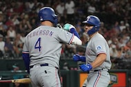 Texas Rangers' Wyatt Langford celebrates with Joc Pederson (4) after hitting a solo home run...