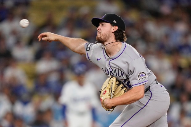 Colorado Rockies starting pitcher Chase Dollander throws to the plate...