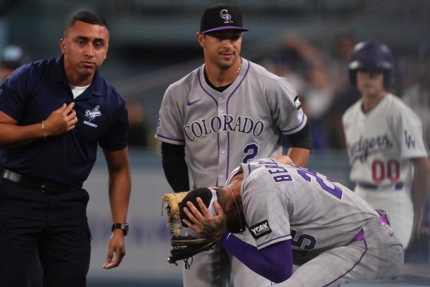 Colorado Rockies first baseman Warming Bernabel holds his head as...