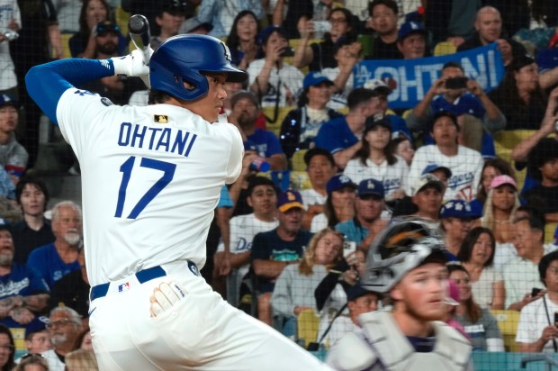 Fans hold up a banner for Dodgers star Shohei Ohtani...