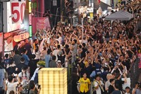Hanshin Tigers fans celebrate in the Dotonbori district of Osaka's Chuo Ward after their team clinched the Central League title on Sept. 7, 2025. (Mainichi/Takao Kitamura)