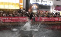 People jump into the Dotonbori River in Osaka's Chuo Ward on Sept. 7, 2025, following the Hanshin Tigers' victory in the Central League title race the same day. (Mainichi/Hayato Matsubara)