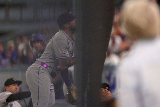 Colorado Rockies first baseman Warming Bernabel runs into fencing while...