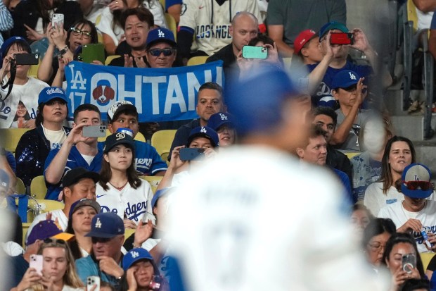Fans hold up a banner for Dodgers star Shohei Ohtani...