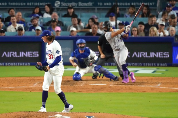 Dodgers starting pitcher Tyler Glasnow, left, celebrates after striking out...