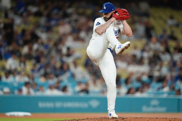 Dodgers relief pitcher Tanner Scott throws to the plate during...