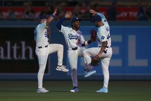 Dodgers outfielders Alex Call, left, Justin Dean, center, and Andy...