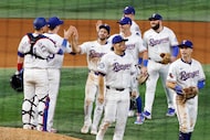 Texas Rangers players celebrate their 6-3 victory agonist Milwaukee Brewers after a baseball...