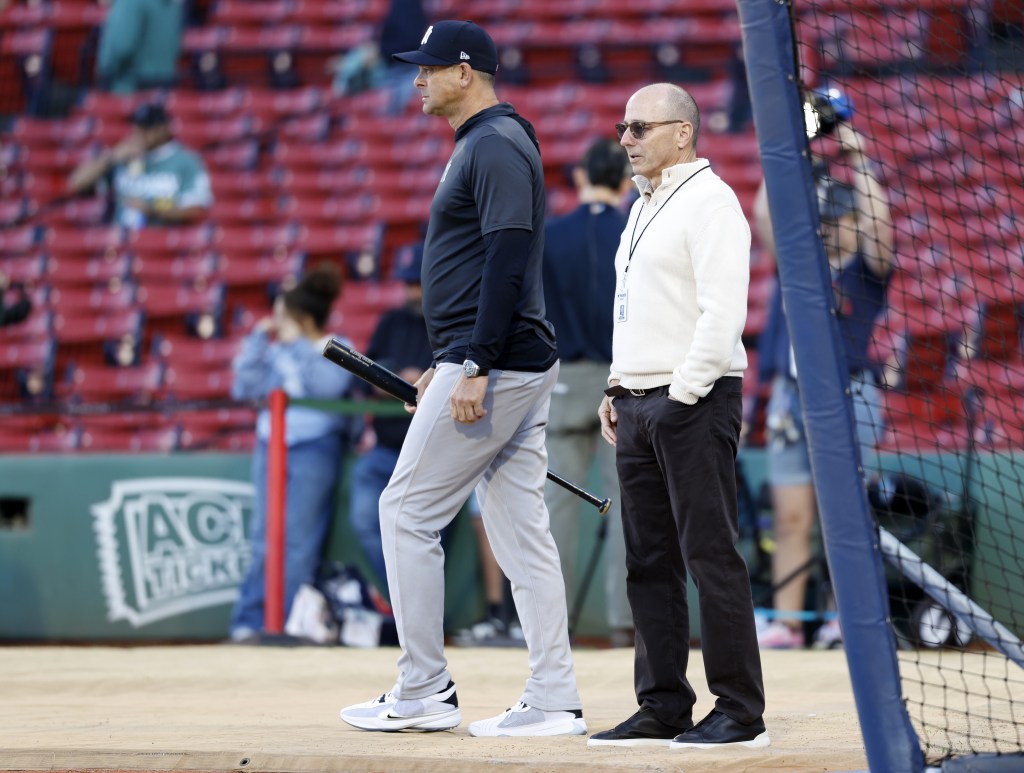 General manager Brian Cashman and manager Aaron Boone look on during warmups before the Yankees' 4-1 win over the Red Sox on Sept. 13, 2025.